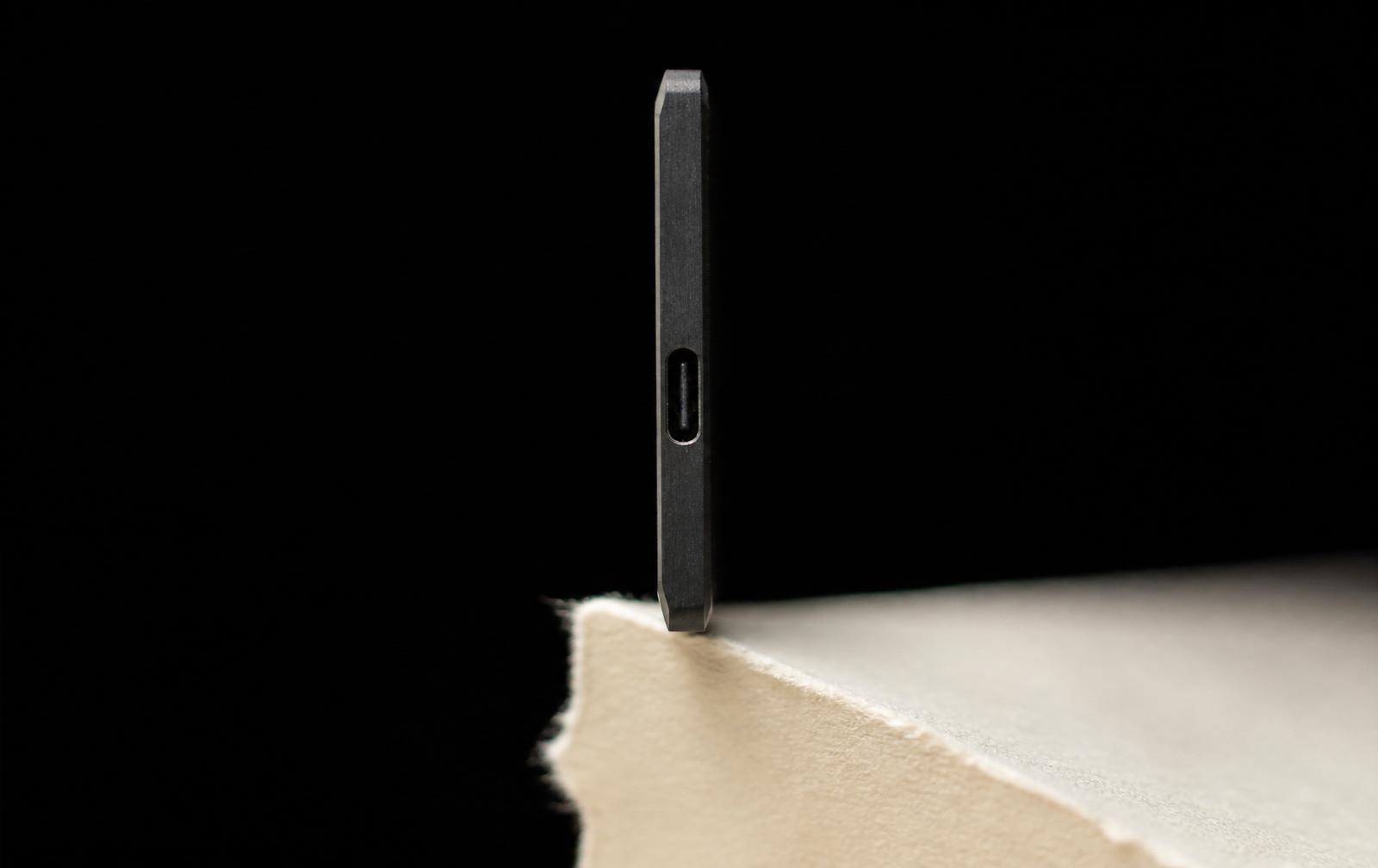 Side profile of TransNote showing its 3.8mm ultra-thin body with USB-C port on cream paper